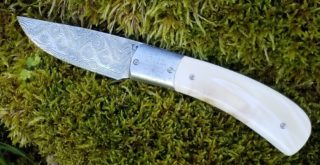 damasteel couteau liner titane phacochère